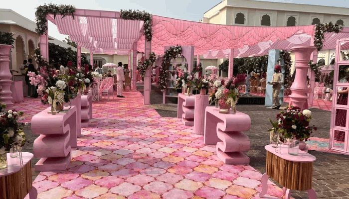 Floral-lined reception pathway and pastel decor designed by TVD Global